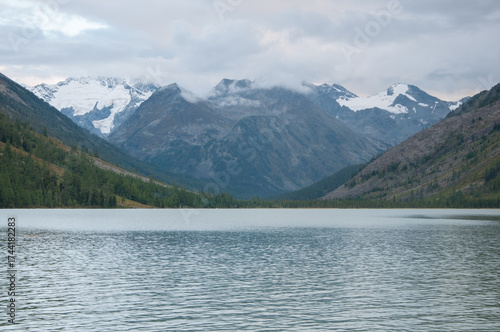 Evening view of Middle Multinskoye lake with snow-covered Altai mountains in the background, Russian Federation