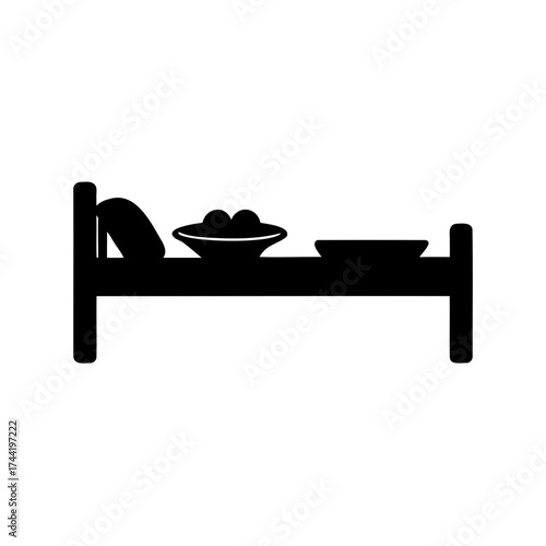 Iconic representation of a bed with pillow and food on dishes