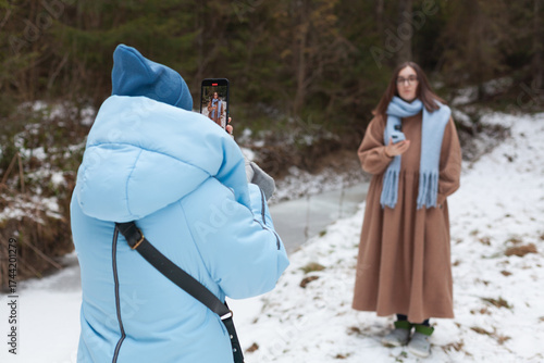 Winter bloggers capturing moments in a snowy forest