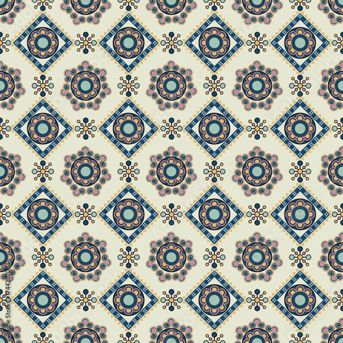 Vintage seamless geometric floral pattern on a cream background. Mediterranean and Moroccan tile style with stylized flower and mandala motifs in muted blue, pink, and gold tones for fabric wallpaper.