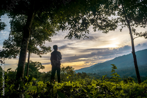 A man looking at mountain sunset