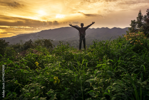 A man looking at mountain sunset