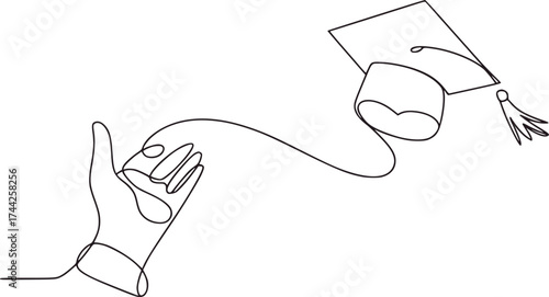 Hand reaching for graduation cap with tassel education