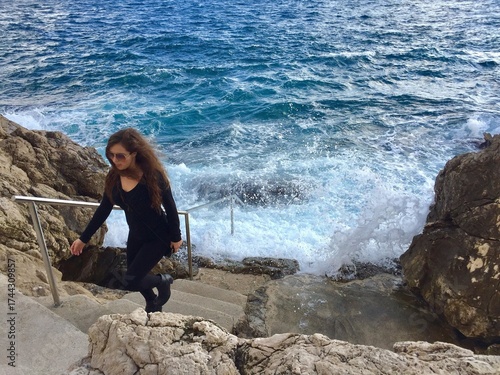 woman on the rocks off the coast of Croatia