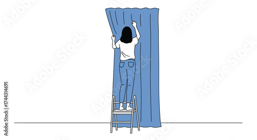 Woman standing on chair hanging a blue curtain in a room
