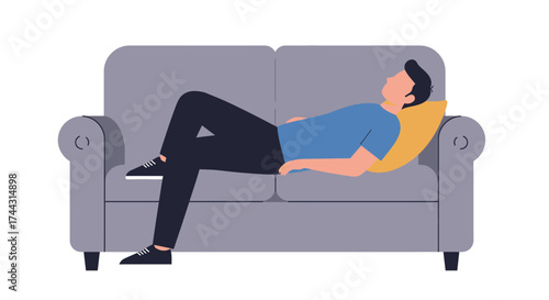 A relaxed man is lying comfortably on a grey sofa indoors