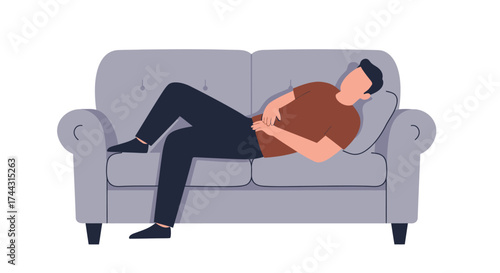 A relaxed man is lounging comfortably on a grey cushioned sofa