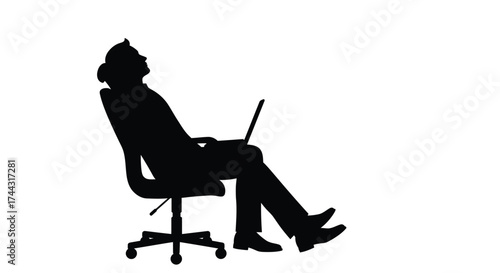 Silhouette of a person relaxing in a chair with a laptop