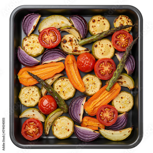 Assorted roasted vegetables on black baking tray top view  
