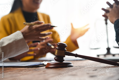 Wallpaper Mural Lawyers and clients meeting to discuss legal consultation, justice system, and regulations. Gavel and scales of justice on desk Torontodigital.ca