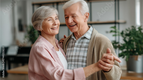 An elderly couple dancing slowly in their living room, nostalgic atmosphere — blured background, with copy space.