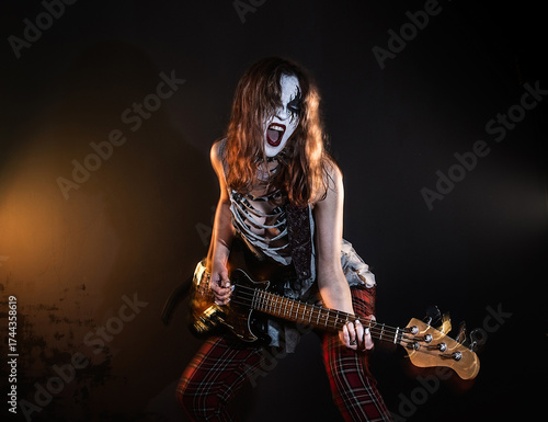 Energetic Female Rock Musician Playing Electric Bass