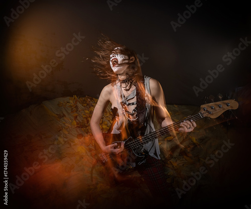 A female rocker with gothic makeup performing metal music during Halloween