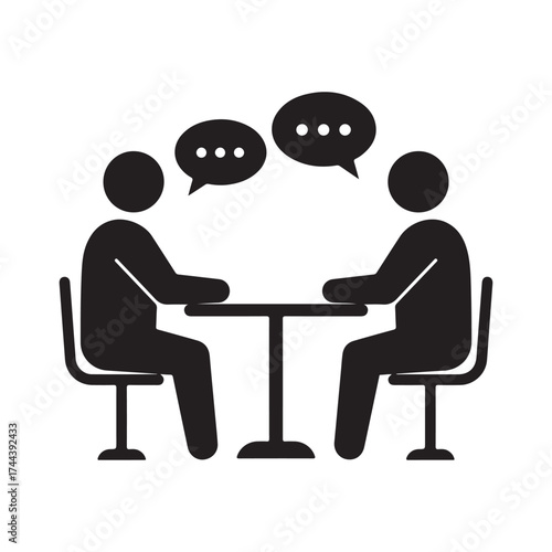 Two people talking across a table with speech bubbles symbolizing communication discussion dialogue