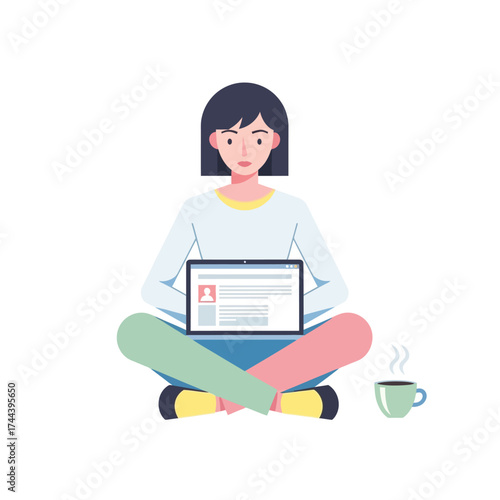 A young woman with short dark hair sits cross-legged on the floor, working on a laptop with a steaming cup of coffee beside her.