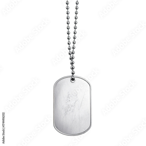 A silver dog tag, scratched and worn, hangs from a ball chain against a black background