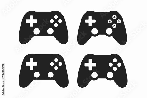 Set of four black game controllers with button variations