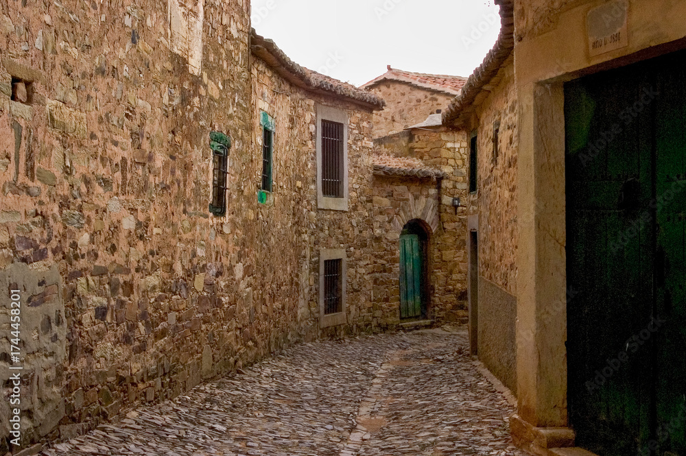 Fototapeta premium Old stone village street with traditional architecture