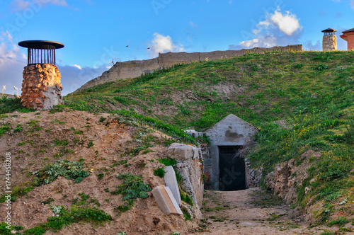 Traditional underground building entrance blending into hill