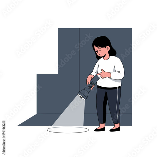 Girl using flashlight to examine the ground in a dim room for Halloween  
