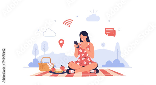A young woman using her smartphone while enjoying a picnic in nature