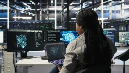 Tableau sur toile Server room IT expert using laptop to apply artificial intelligence technology minimizing system downtime