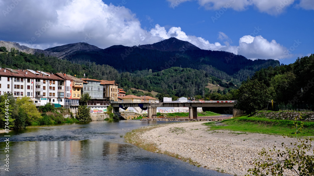 Fototapeta premium A picturesque video of the town of Arriondas in Asturias, Spain, with a tranquil river flowing through it.
