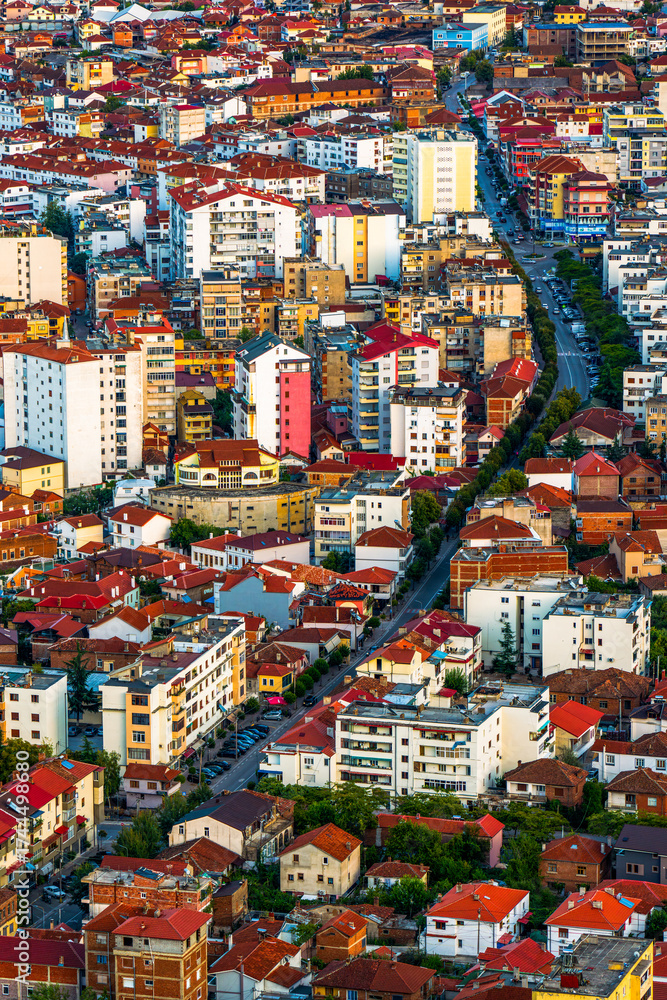 Naklejka premium Aerial View of Pogradec City with Colorful Buildings and Red Tiled Roofs at Sunset, Albania