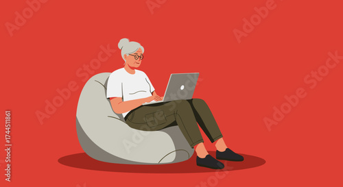Smiling senior woman working on laptop from a bean bag chair Modern technology and remote work