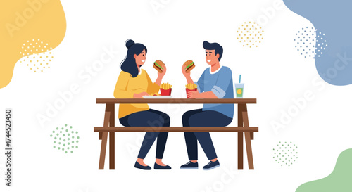 Couple Enjoying Outdoor Lunch With Hamburgers, Fries, and Refreshments at Wooden Table