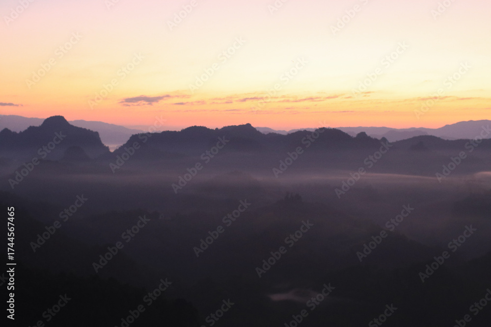 Fototapeta premium Beautiful morning mountains range and mist with the sunrise. Creating a peaceful and atmospheric. Before sunrise. 