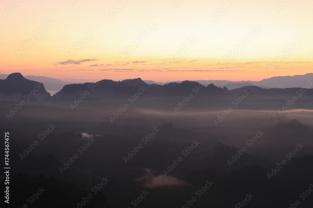 Fototapeta premium Beautiful morning mountains range and mist with the sunrise. Creating a peaceful and atmospheric. Before sunrise. 