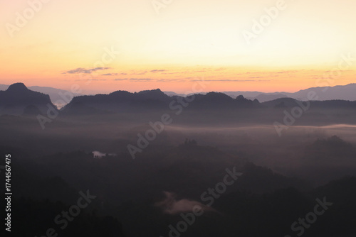 Beautiful morning mountains range and mist with the sunrise. Creating a peaceful and atmospheric. Before sunrise. 