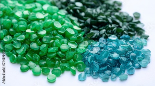 Green granules of polypropylene or polyamide on a white background. Plastics and polymers industry. Copy space. Glass petri dish