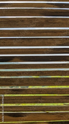 Close-up view reveals a stack of bamboo planks, showing texture and grain.
