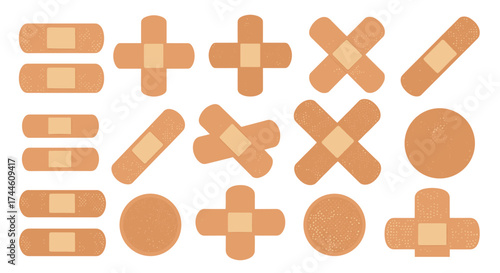 A collection of diverse first aid bandage strips and crosses for minor wound care applications.