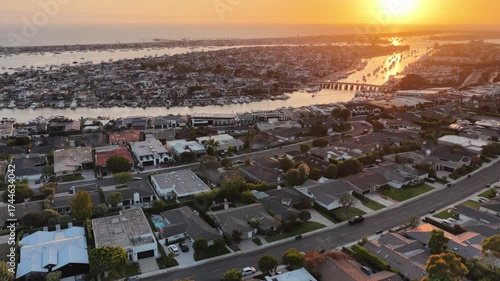 Aerial drone shot of coastal Orange County in California at sunset with Newport Beach harbor and the Pacific ocean