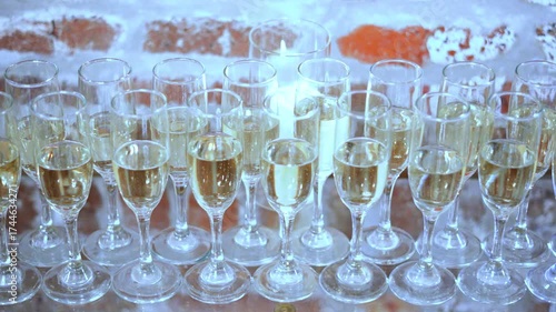 Row of champagne on table at a wedding reception ready to be served