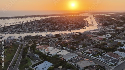 Aerial view of coastal Orange County in California at sunset with Newport Beach harbor and the Pacific ocean