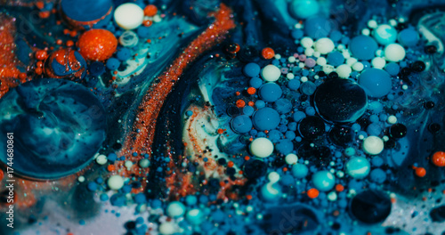 Color bubbles. Oil fluid. Defocused blue orange purple ink glitter acrylic water shiny round texture floating on abstract art background.