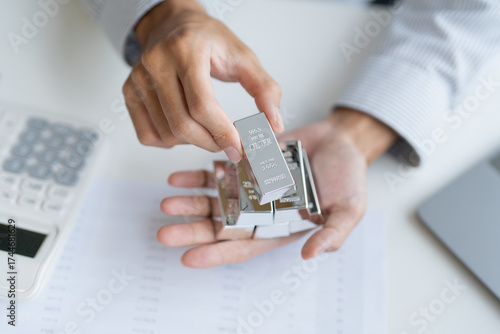 Silver bar Trading business man hand offering silver Investment financial report Trading Pure silver precious metals investment  on the stock exchange Rising prices.