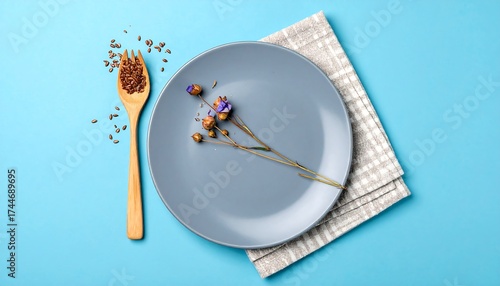 Empty gray plate with napkin and wooden spoon