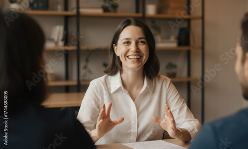 Smiling Woman Engaged in Conversation at a Table
