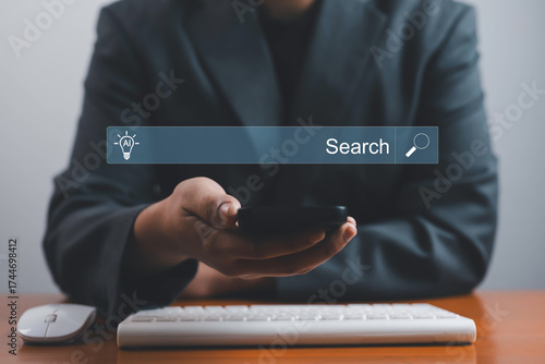 Foto Businessman using smartphone with AI search bar interface, representing artificial intelligence technology, digital innovation, and smart online information searching in modern business