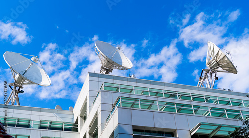 Satellite on building. Architectural design of building. Broadcasting building architecture. Architectural exterior detail. Broadcasting exterior fragment. Modern building with satellite.