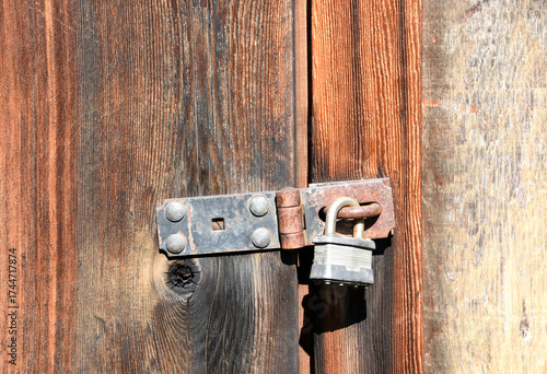 Padlock on an old rustic building door