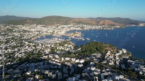 Bodrum, Turkey : Aerial drone footage of marina in Bodrum, popular beach holiday destination in Turkey. Showing the castle and mountains in the background on sunny day. Taken with tilt up motion