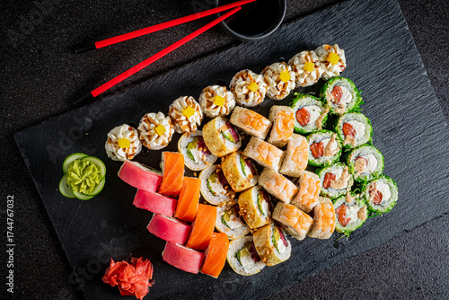 Photos A vibrant assortment of sushi rolls beautifully displayed with wasabi and pickle