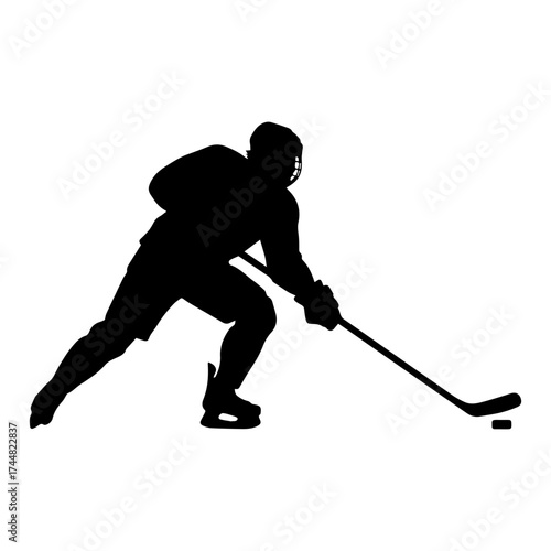 Silhouette of hockey player skating on ice with puck