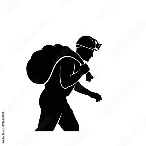 Silhouette of a miner carrying a large sack on his back.